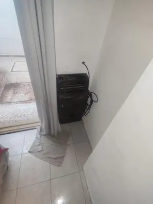 a corner of a room with a heater in a wall at San Jerónimo Residential Apartaments in Cordoba