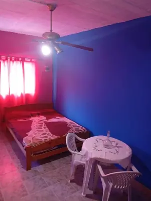 a bedroom with a bed and a table and a ceiling at Albricias in Mina Clavero