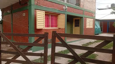 a wooden fence in front of a building at Albricias in Mina Clavero
