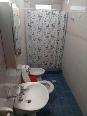 a bathroom with two toilets and a sink and a shower at Albricias in Mina Clavero