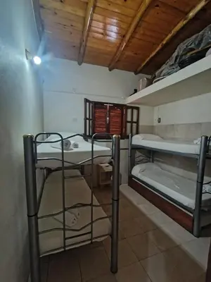 a room with two bunk beds and a window at Complejo los lirios in Villa Los Aromos