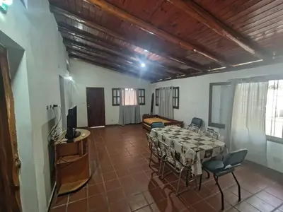 a dining room with a table and chairs in a room at Complejo los lirios in Villa Los Aromos