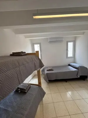 a room with two beds and a futon in it at La Casa de la Colina in Cordoba