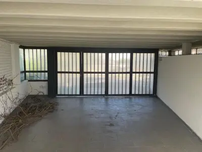 an empty room with doors and windows in a building at La Casa de la Colina in Cordoba
