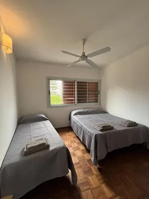 a bedroom with two beds and a ceiling fan at La Casa de la Colina in Cordoba