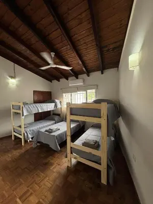 two bunk beds in a room with a wooden ceiling at La Casa de la Colina in Cordoba
