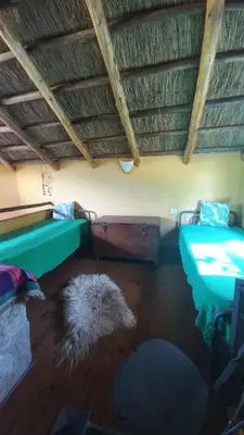 a room with a couch and a table and a rug at Cabañas Bendita Tierra- Crespin in Los Molles
