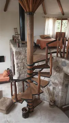 a bedroom with a bed and a wooden stove at Cabañas Bendita Tierra - Calandrias in Los Molles
