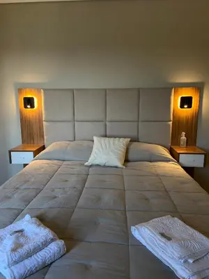 a large bed with two pillows on top of it at Departamento 2 dor Calidad seguridad 24h complejo cerrado in Cordoba