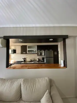 a living room with a couch and a mirror on the wall at Departamento 2 dor Calidad seguridad 24h complejo cerrado in Cordoba