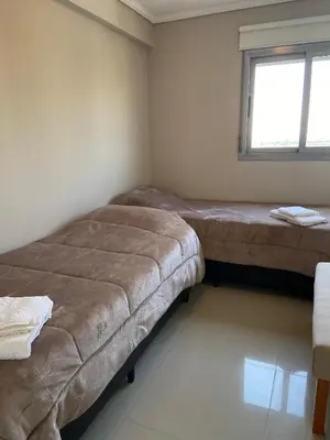 a small room with two beds and a window at Departamento 2 dor Calidad seguridad 24h complejo cerrado in Cordoba
