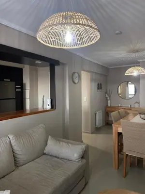 a living room with a couch and a table at Departamento 2 dor Calidad seguridad 24h complejo cerrado in Cordoba