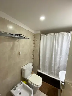 a bathroom with a toilet and a shower and a sink at Departamento 2 dor Calidad seguridad 24h complejo cerrado in Cordoba