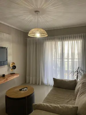 a living room with a couch and a chandelier at Departamento 2 dor Calidad seguridad 24h complejo cerrado in Cordoba