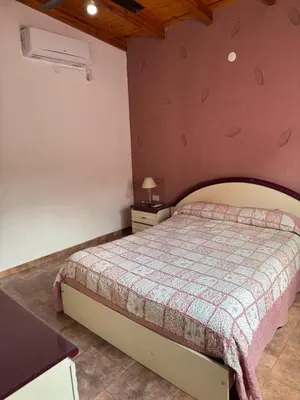 a bedroom with a bed in a room at Lodemarta in Villa Carlos Paz