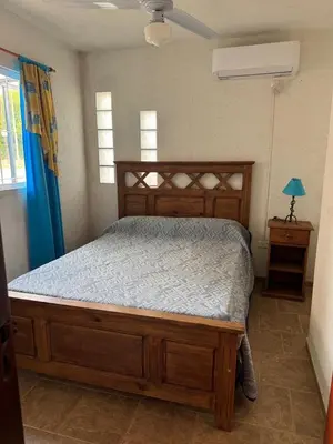 a bedroom with a large wooden bed in a room at Lodemarta in Villa Carlos Paz