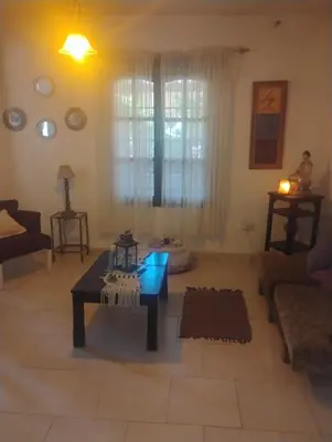 a living room with a table and a blue light at Casa de campo con pileta in Alta Gracia
