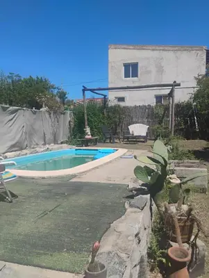 a swimming pool in the yard of a house at Casa de campo con pileta in Alta Gracia