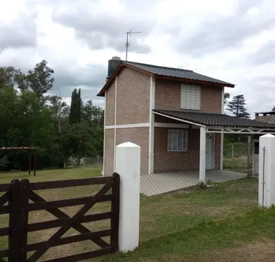 a house with a fence in front of it at Tanti casita del rio in Tanti Nuevo