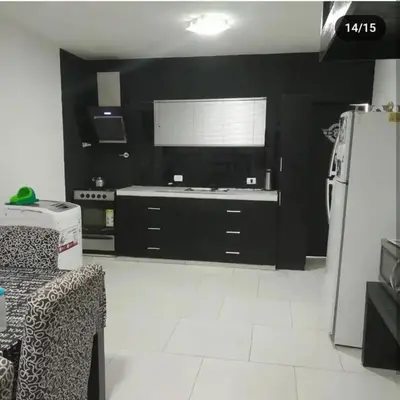 a kitchen with black walls and a white floor at Doña LoIa in San Roque