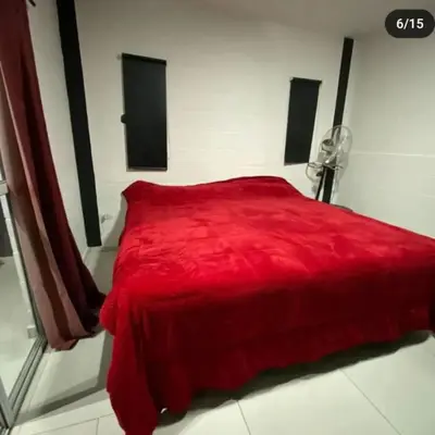 a red bed in a white room with a red blanket at Doña LoIa in San Roque