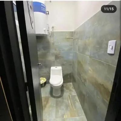 a small bathroom with a toilet in a stall at Doña LoIa in San Roque