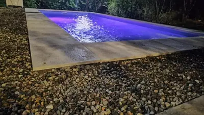 a swimming pool with a purple pool at Doña LoIa in San Roque