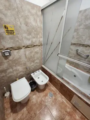 a bathroom with a toilet and a shower and a sink at Aparts Solares in San Antonio de Arredondo