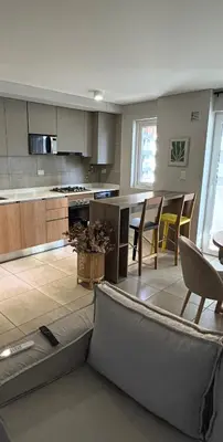 a large kitchen with a table and chairs in it at Departamento Premium con Pileta en Altura in Cordoba