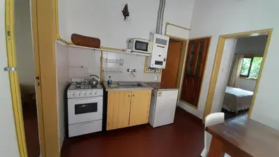 a small kitchen with a stove and a sink at Bungalows Aguas Claras in Villa del Dique