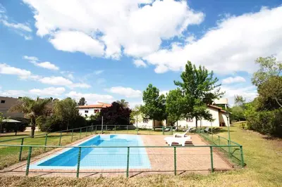 a swimming pool with a bench next to a house at Bungalows Aguas Claras in Villa del Dique