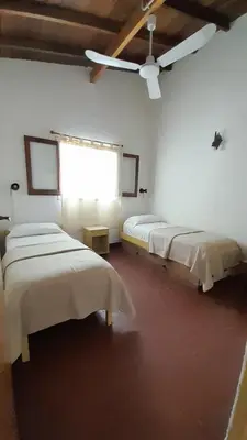 two beds in a room with a window at Bungalows Aguas Claras in Villa del Dique