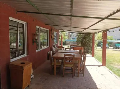 a wooden table and chairs on a patio at Bungalows Aguas Claras in Villa del Dique