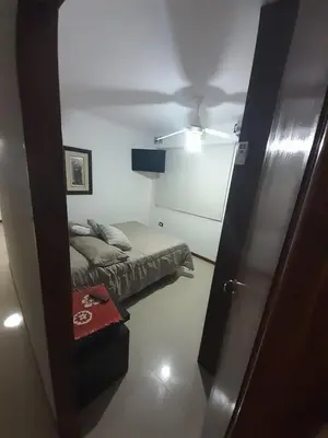 a small room with a bed and a mirror at Miralejos 6 in Villa Carlos Paz
