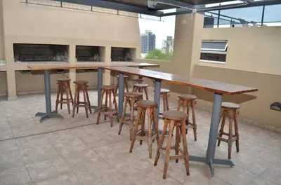 a bar with stools and tables on a building at Miralejos 6 in Villa Carlos Paz