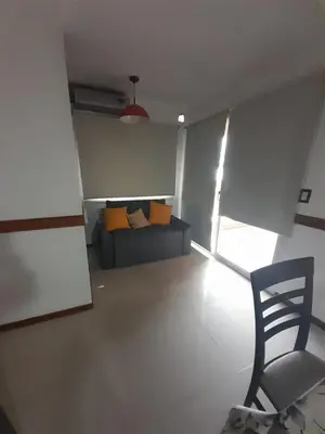 a living room with a couch and a chair at Miralejos 6 in Villa Carlos Paz