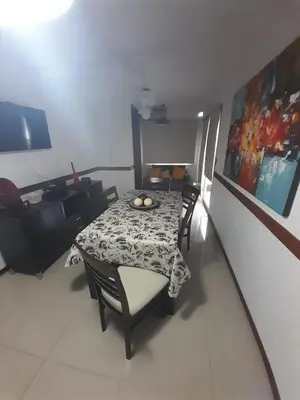 a dining room with a table and chairs and a painting at Miralejos 6 in Villa Carlos Paz