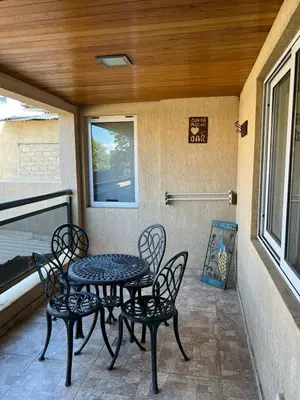 a patio with a table and chairs on a porch at Miralejos 6 in Villa Carlos Paz