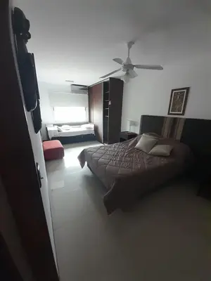 a bedroom with two beds and a ceiling fan at Miralejos 6 in Villa Carlos Paz