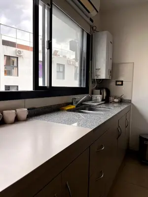 a kitchen with a sink and a window at depto a 1 cuadra de peatonal, luminoso con pile y cochera in Villa Carlos Paz