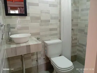 a bathroom with a toilet and a sink at Cabañas ojo de aguila in Panaholma