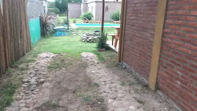 a backyard with a pool and a brick wall at Cabañas ojo de aguila in Panaholma