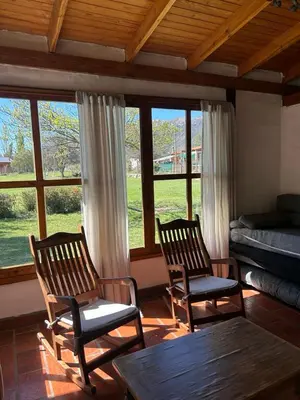two chairs and a table in a room with windows at Rincón del Benítez in Cortaderas