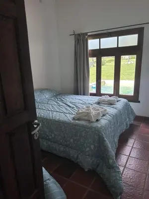 a bedroom with a bed and a window at Rincón del Benítez in Cortaderas