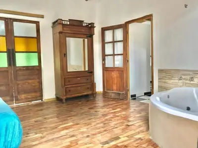 a bathroom with a tub and a dresser and a sink at Rincón del Benítez in Cortaderas