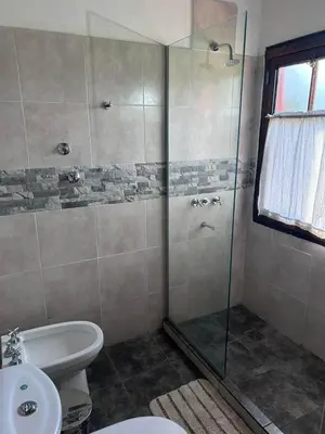 a bathroom with a shower with a toilet and a sink at Rincón del Benítez in Cortaderas