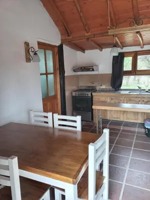 a kitchen with a wooden table and a stove at Rincón del Benítez in Cortaderas