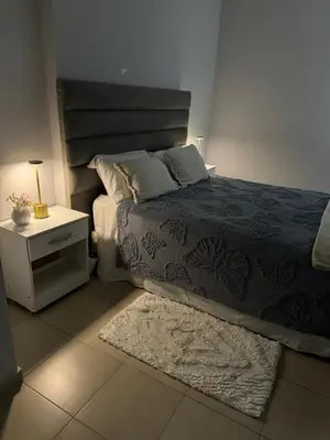 a bedroom with a bed and a nightstand with a bed sidx sidx at Casino Villa Carlos Paz in Villa Carlos Paz