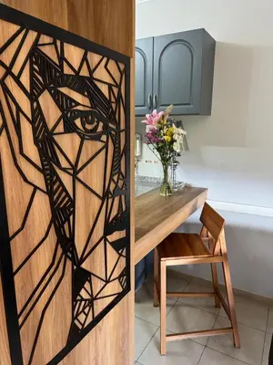 a room with a table and a window with an eye design at Casino Villa Carlos Paz in Villa Carlos Paz