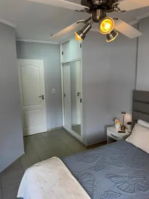 a bedroom with a bed and a ceiling fan at Casino Villa Carlos Paz in Villa Carlos Paz